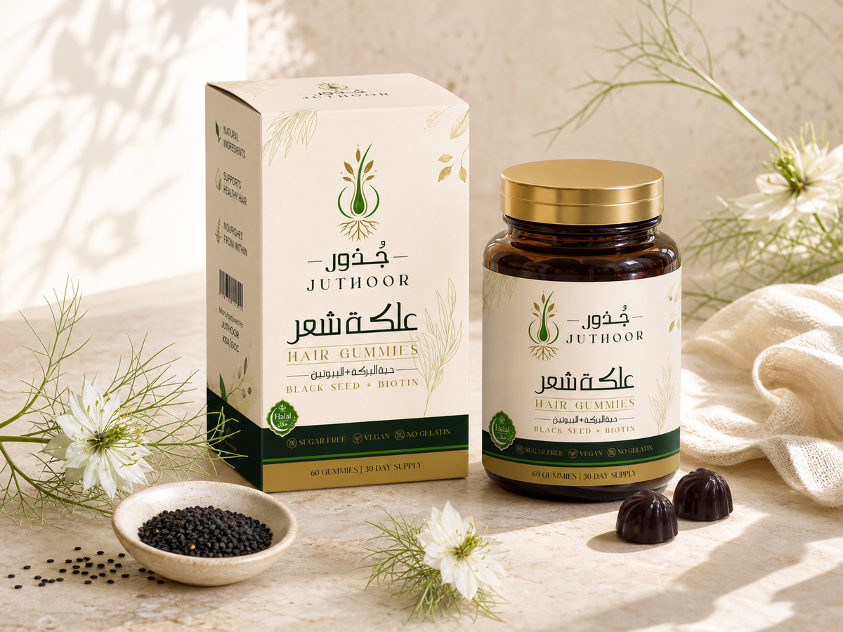 A hand holding the Juthoor jar beside its carton on a bathroom counter